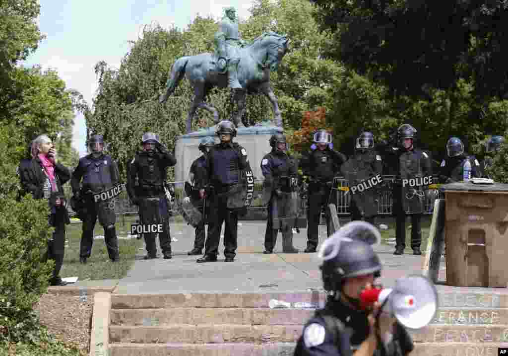 State Police in riot gear guard Lee Park after a white nationalist demonstration was declared illegal and the park was cleared in Charlottesville, Va., Aug. 12, 2017. 