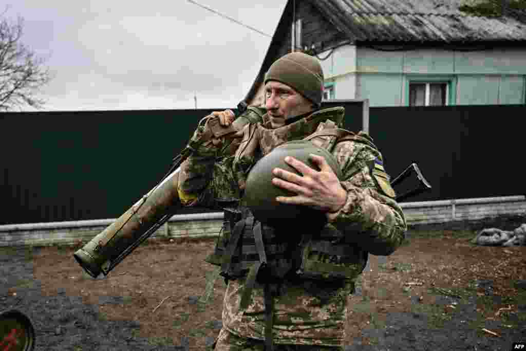 An Ukrainian soldier holds an anti-tank launcher at a frontline, northeast of Kyiv, March 3, 2022. 