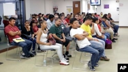 Mexican nationals wait to be seen at the Mexican consulate, March 3, 2017, in Miami.