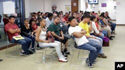 Mexican nationals wait to be seen at the Consulate General of Mexico, March 3, 2017, in Miami.