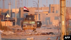 A member of Iraq's counter-terrorism forces monitors his surrounding in a street in Ramadi's Dhubbat neighberhood, adjacent to Hoz neighborhood, Dec. 25, 2015. 