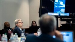 William "Roddie" Bryan, left, watches a video as defense attorney Kevin Gough, right, presents a closing statements during the trial of he and Travis McMichael, and his father, Gregory McMichael, Nov. 22, 2021, in Brunswick, Ga.