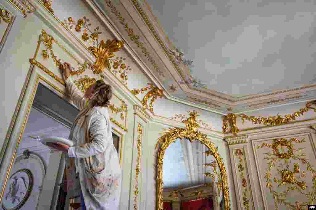 A painter adds finishing touches to ornamental decoration inside the &quot;Villa La Grange&quot; where U.S. President Joe Biden and Russian President Vladimir Putin are scheduled to meet June 16, in Geneva. 