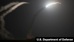 The guided-missile cruiser USS Philippine Sea launches a Tomahawk cruise missile at a target in Syria.