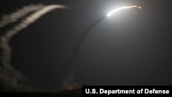 The guided-missile cruiser USS Philippine Sea (CG 58) launches a Tomahawk cruise missile to conduct strikes against ISIL targets as seen from the aircraft carrier USS George H.W. Bush (CVN 77). (U.S. Navy photo by Mass Communication Specialist 1st Class Eric Garst) 