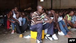 Men sit in the Gikondo transit center in Kigali, Sept. 24, 2015. Human Rights Watch accused the Rwanda government of rounding up "undesirables," including beggars and prostitutes, and holding them in the center to promote the capital's clean image, a charge denied by the government.