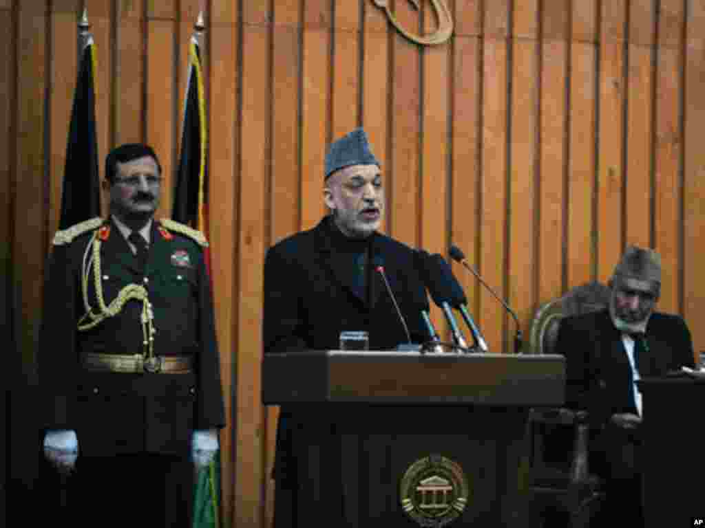Afghan President Hamid Karzai (L) speaks during a ceremony for newly-elected members of parliament in Kabul, January 26, 2011. Karzai opened parliament on Wednesday, ending a standoff with lawmakers, but setting the stage for a longer battle against an a