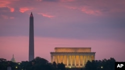 Sunrise behind the Washington and Lincoln memorials.