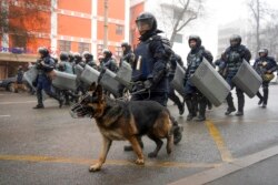 FILE - Riot police walk to block demonstrators gathering during a protest in Almaty, Kazakhstan, Jan. 5, 2022.