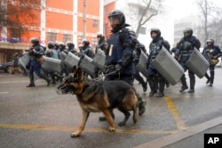 FILE - Riot police walk to block demonstrators gathering during a protest in Almaty, Kazakhstan, Jan. 5, 2022.