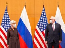FILE - U.S. Deputy Secretary of State Wendy Sherman, left, and Russian deputy foreign minister Sergei Ryabkov attend security talks at the United States Mission in Geneva, Switzerland, Jan. 10, 2022.