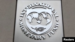 FILE - The International Monetary Fund (IMF) logo is seen at the IMF headquarters building during the 2013 Spring Meeting of the International Monetary Fund and World Bank in Washington.
