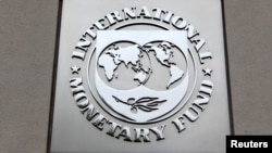 FILE - The International Monetary Fund (IMF) logo is seen at the IMF headquarters building during the 2013 Spring Meeting of the International Monetary Fund and World Bank in Washington.