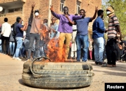 Sudanese demonstrators burn a tire as they participate in anti-government protests in Khartoum, Sudan, Jan. 17, 2019.