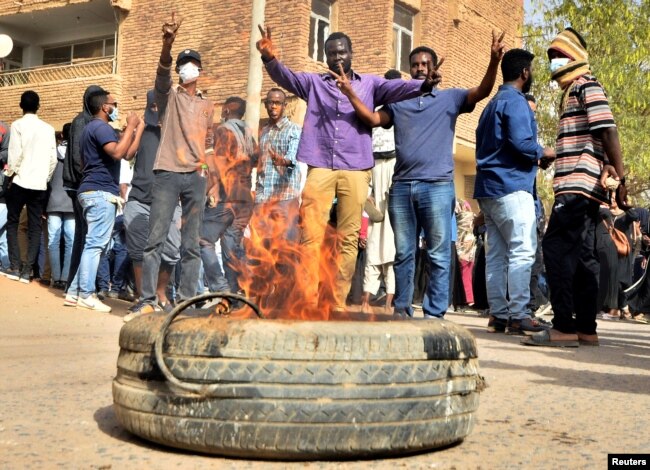 Sudanese demonstrators burn a tire as they participate in anti-government protests in Khartoum, Sudan, Jan. 17, 2019.