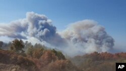 This photo provided by California Department of Forestry and Fire Protection shows smoke billowing from a wildfire near Lake Nacimiento in San Luis Obispo County, Calif., Aug. 20, 2016. 
