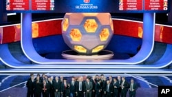 The coaches of the qualified teams pose for a group photo at the end of the 2018 soccer World Cup draw in the Kremlin in Moscow, Dec. 1, 2017.