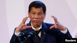FILE - Philippines' President Rodrigo Duterte gestures during a news conference on the sidelines of the Association of South East Asian Nations summit in Pasay, metro Manila, Philippines, Nov. 14, 2017. Duterte has ended peace talks with Maoist-led rebels