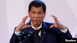 FILE - Philippines' President Rodrigo Duterte gestures during a news conference on the sidelines of the Association of South East Asian Nations summit in Pasay, metro Manila, Philippines, Nov. 14, 2017. 