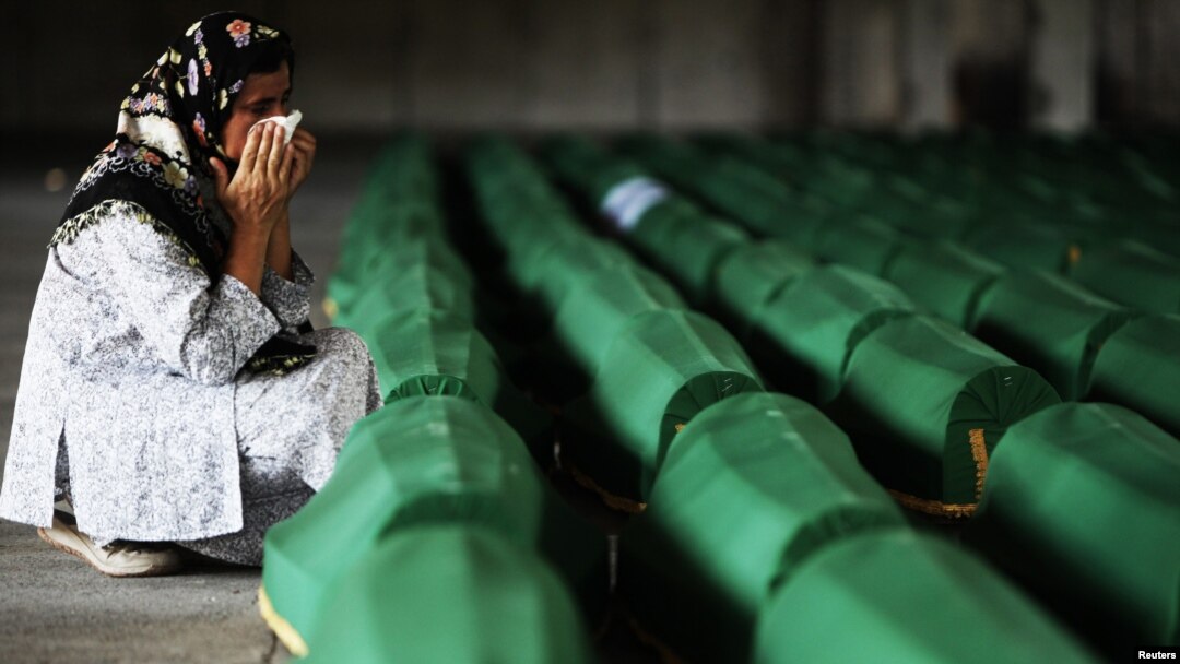 A Bosnian Muslim cries near the coffin of her relative, which was prepared for a mass burial at the Memorial Center in Potocari, near Srebrenica, July 10, 2012.