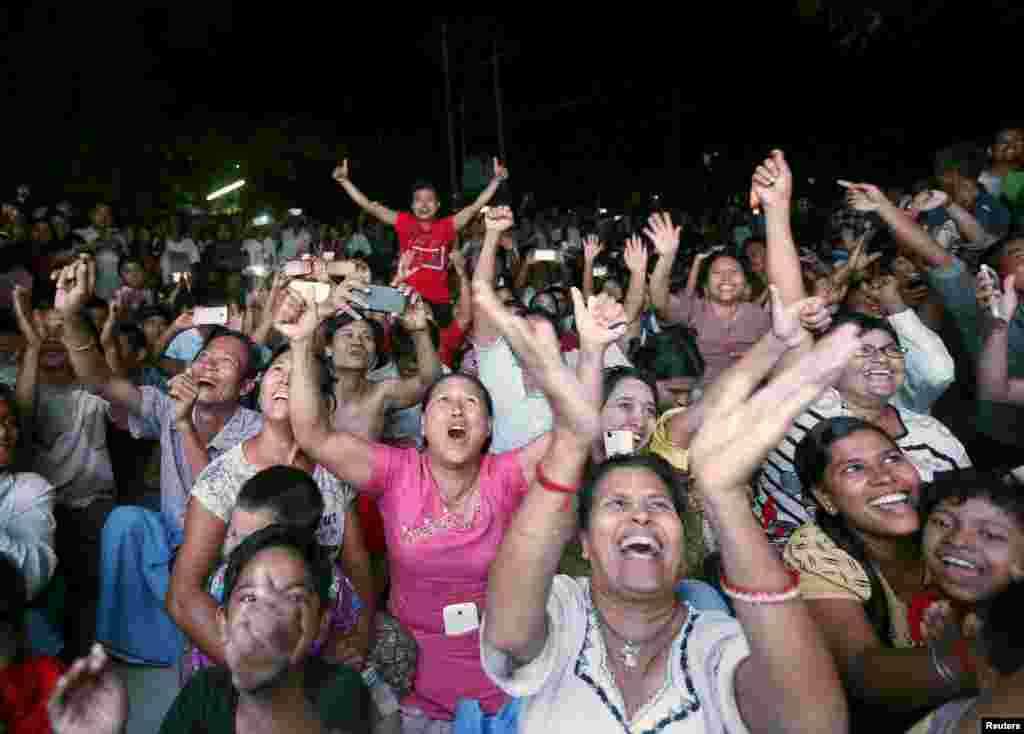 Supporters of National League for Democracy (NLD) leader Aung San Suu Kyi cheer as they watch partial election results on a TV monitor outside NLD offices in Mandalay. Myanmar held its first free nationwide election in 25 years, the biggest step yet in a journey to democracy from dictatorship.