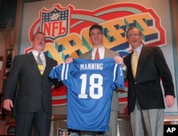 FILE - In this April 18, 1998, file photo, Peyton Manning holds up an Indianapolis Colts jersey as he is flanked by Colts owner Jim Irsay, left, and NFL Commissioner Paul Tagliabue after being chosen as the No.