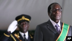 Zimbabwean President Robert Mugabe, right, is seen, at his inauguration ceremony at State house in Harare, Sunday, June, 29, 2008.