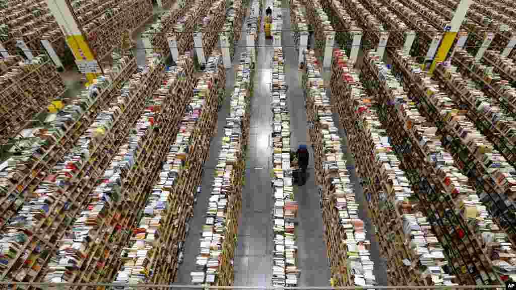An Amazon.com employee stocks products along one of the many miles of aisles at an Amazon.com Fulfillment Center on &quot;Cyber Monday&quot; the busiest online shopping day of the holiday season in Phoenix, Arizona, USA, Dec. 2, 2013. 