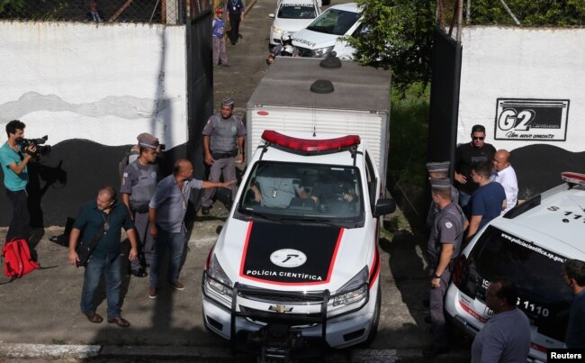 A vehicle of the forensic team leaves the Raul Brasil school after a shooting in Suzano, Sao Paulo state, Brazil, March 13, 2019.