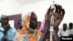 FILE - Staff members of a teaching hospital receive the first vaccination treatment for yellow fever in El Geneina, West Darfur, Nov. 14, 2012.