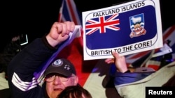 Falkland islanders react after hearing the results of the referendum in Stanley, March 11, 2013. Residents of the Falkland Islands voted almost unanimously to stay under British rule.
