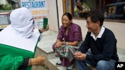 A Tibetan man and woman listen as the 'Green Book Man' explains to them the need to register themselves for the Kalon Tripa and parliamentary elections of 2011 before August 18, 2010, the deadline for registration of voters. Tibetans will go to preliminar