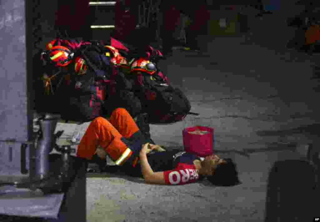 A rescue worker rests near the site of a derailed train near the Taroko Gorge area in Hualien, Taiwan.