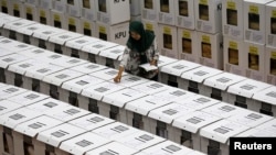 An official prepares ballot boxes before their distribution to polling stations in a warehouse in Jakarta, Indonesia, Apr. 15, 2019. 