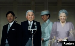 Japan's Crown Prince Naruhito (L-R), Emperor Akihito, Crown Princess Masako and Empress Michiko stand in front of well-wishers who gathered to celebrate the monarch's 80th birthday at the Imperial Palace in Tokyo, December 23, 2013.