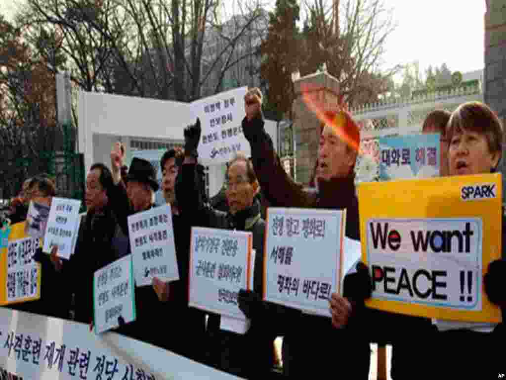 South Korean protesters shout slogans during a rally denouncing South Korea's live-fire drills on Yeonpyeong Island, in front of Defense Ministry in Seoul, South Korea, Friday, Dec. 17, 2010. South Korea's Joint Chiefs of Staffs said in a statement that m