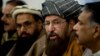 FILE - Pakistani religious cleric, Sami-ul-Haq, second right, addresses a news conference with, Hameed Gul, former chief of Pakistan's intelligence, left, in Islamabad, Pakistan, Feb. 3, 2014.