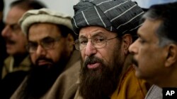 FILE - Pakistani religious cleric, Sami-ul-Haq, second right, addresses a news conference with, Hameed Gul, former chief of Pakistan's intelligence, left, in Islamabad, Pakistan, Feb. 3, 2014.