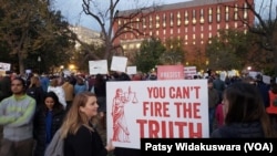 Several hundred demonstrators, some carrying signs of "Trump is not above the law" and "You can't fire the truth," gathered outside the White House and in Lafayette Park, just north of the White House, in Washington, Nov. 8, 2018.