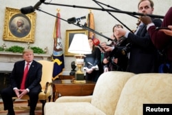 U.S. President Donald Trump listens to a reporter's question while meeting with NATO Secretary General Jens Stoltenberg in the Oval Office at the White House in Washington, April 2, 2019.