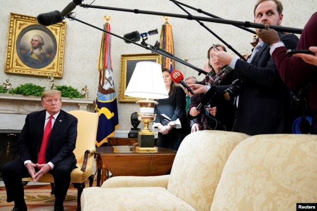 U.S. President Donald Trump listens to a reporter's question while meeting with NATO Secretary General Jens Stoltenberg in the Oval Office at the White House in Washington, April 2, 2019.