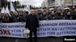 Police officers take part in a rally of uniformed staff of the public sector as they protest against planned pension reforms in central Athens, Greece, Feb. 5, 2016. Greece and its official lenders must conclude a first assessment of the country's compliance with agreed reforms as fast as possible, the government's spokeswoman said on Feb. 9, 2016.