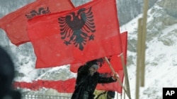 Kosovo Albanians set up Albanian national flags in the town of Kacanik, southeast of the capital Pristina, February 16, 2012. Kosovo celebrates the fourth anniversary of its declaration of independence from Serbia on February 17.