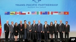Trade delegates pose for a photograph after signing the Trans-Pacific Partnership Agreement in Auckland, New Zealand.