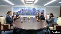 FILE - South Korean President Moon Jae-in and North Korean leader Kim Jong Un attend the inter-Korean summit at the truce village of Panmunjom, in this still frame taken from video, South Korea April 27, 2018.