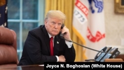 FILE - President Donald J. Trump speaks on the phone in the Oval Office Wednesday, Nov. 14, 2018, 