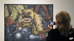 A woman looks at Mexican painter Diego Rivera's 'Indian Warrior' displayed during a preview at New York's Museum of Modern Art, November 8, 2011.