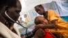 FILE - A doctor examines a young tuberculosis patient who is being held by his mother at the hospital of Doctors Without Borders in Malakal, South Sudan, June 15, 2016.