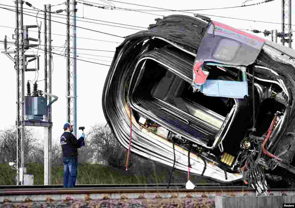 An emergency personnel works after a high speed train traveling from Milan to Bologna derailed near Lodi, Italy, killing at least two people.