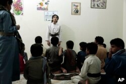 Boys recite poems during a session at a rehabilitation center for former child soldiers in Marib, Yemen, in this July 25, 2018 photo.